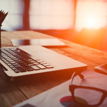 mackeeper mac utilities laptop on desk glasses phone pencils